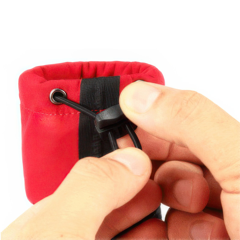 Detailed view of fingers pulling the upper ankle cuff drawstring toggle on adjustable secure fit dog shoes.