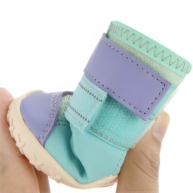 Side close-up of a hand flexing the non-deformation rubber outsole panel of anti-slip rubber sole dog shoes.