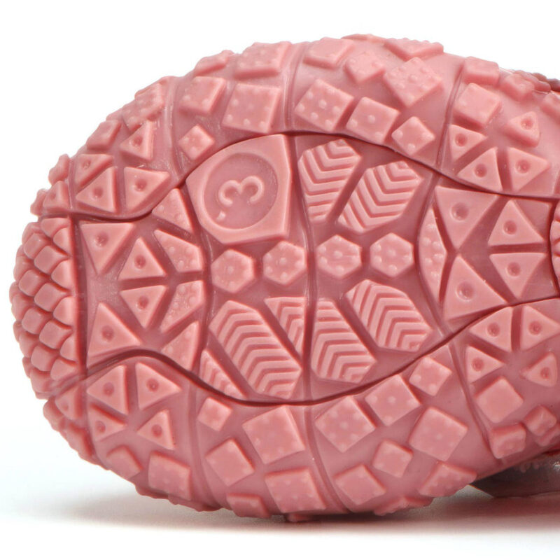 Underneath profile of pink anti-slip TPR sole paw protectors illustrating deep geometric chevron traction block groove networks.