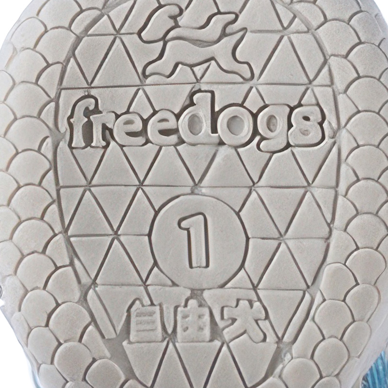 Underneath look at the light grey rubber base on anti-slip tpr sole paw protectors displaying geometric suction channels.
