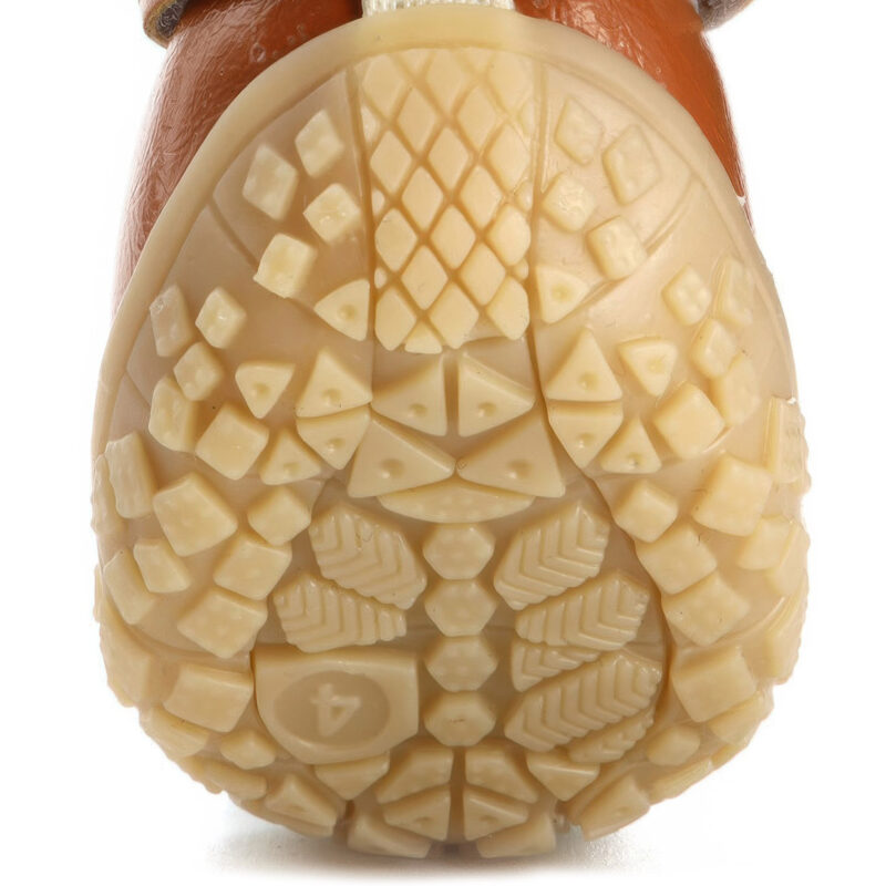 Underneath profile of tan anti-slip tpr sole paw protectors illustrating the deep micro geometric block traction grooves.