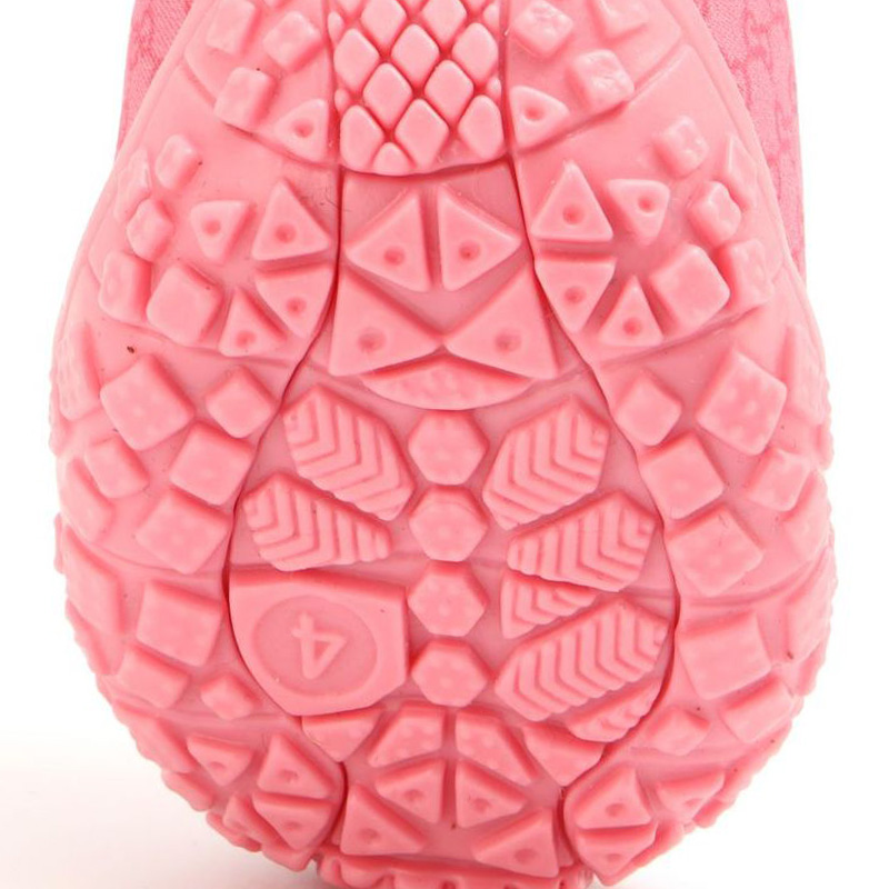 Detailed underfoot view of the geometric multi-directional block tread patterns on anti-slip TPR sole pet shoes.
