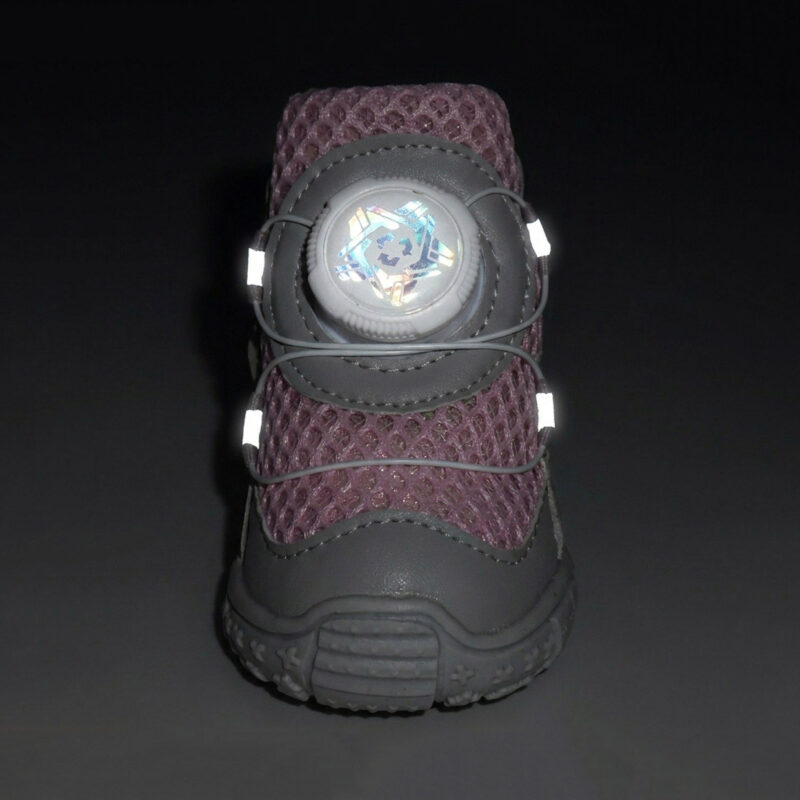 Front view of a lavender breathable dial-fit dog shoe showing white side tracking points glowing under dark conditions.