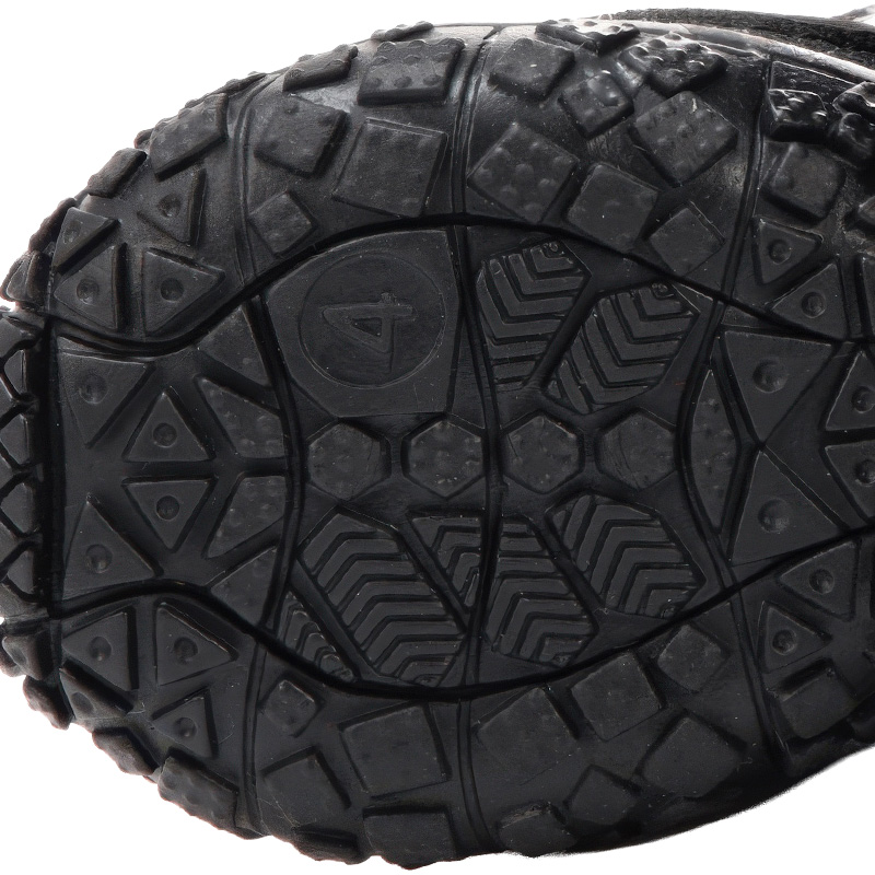 Underneath look at the textured black rubber bottom on comfortable soft-sole puppy shoes highlighting geometric blocks.