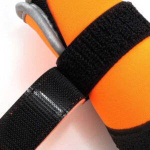 Macro view of orange dog boots with velcro straps showcasing the strong adhesion and soft non chafing fabric.