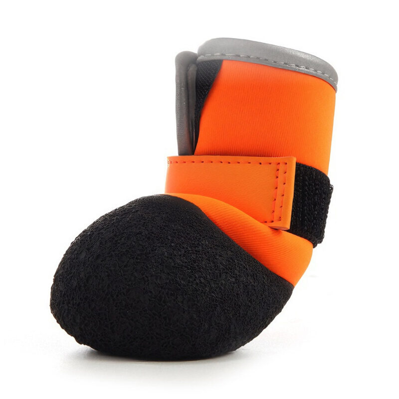 Side view of an orange dog shoe for hot pavement highlighting the thick wrinkled wear resistant sole.