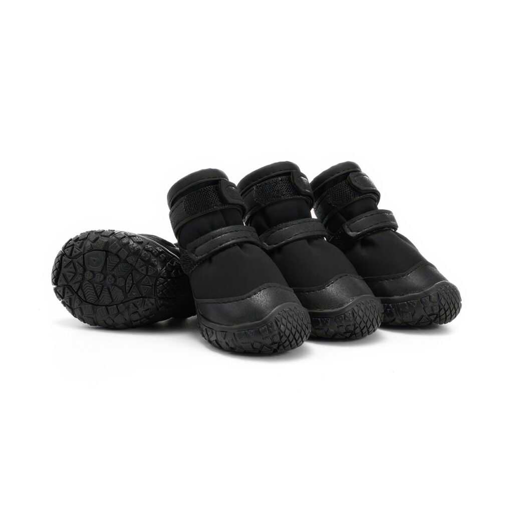 Stealth black double-strap waterproof dog shoes displaying leather mudguards, black TPR soles, and parallel velcro bands.