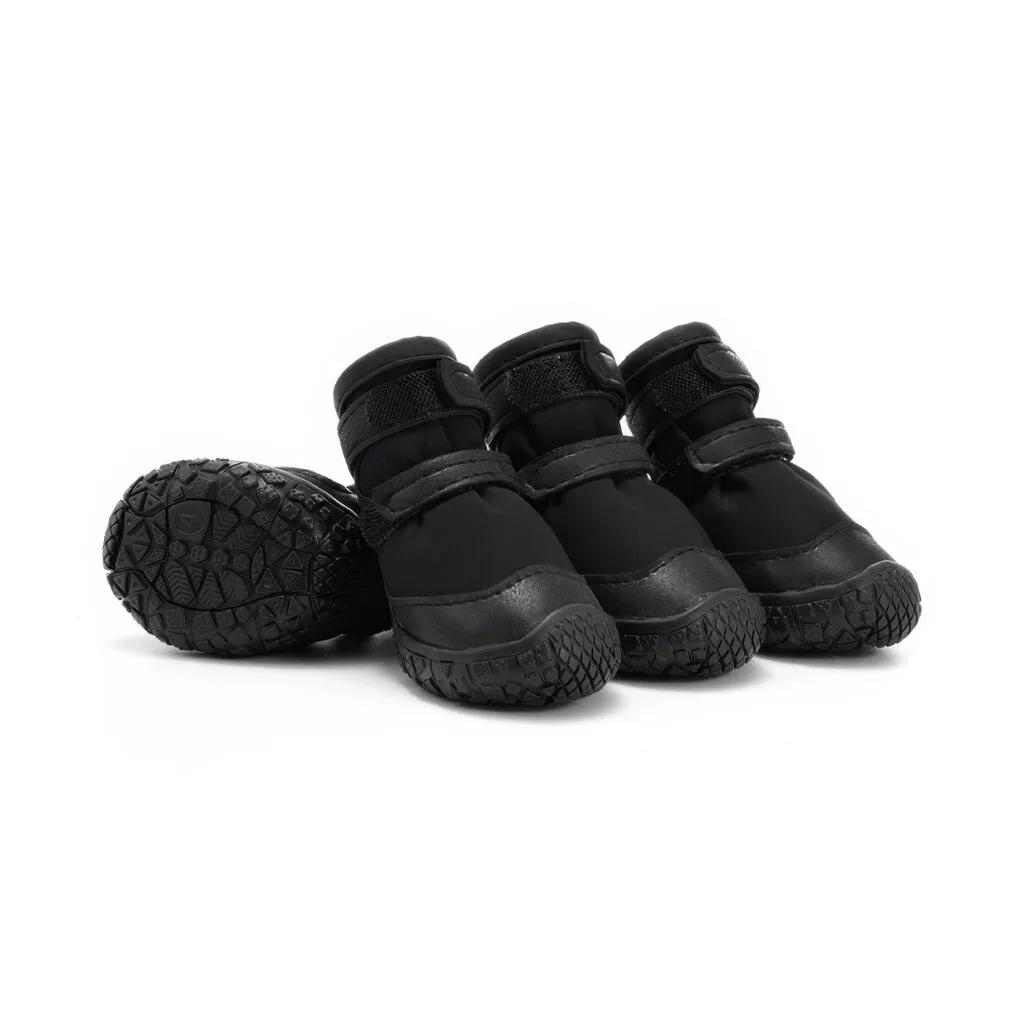 Stealth black double-strap waterproof dog shoes displaying leather mudguards, black TPR soles, and parallel velcro bands.
