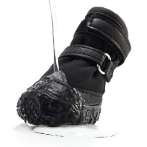 Hydrophobic Fabric Water Repellency Flow Demonstration Running tap water cascading off the hydrophobic shell of black double-strap waterproof dog shoes during testing.