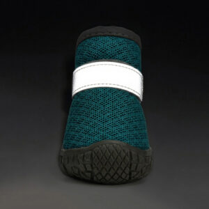 Front view of an ocean teal double wrap strap stay-on puppy shoe with its horizontal ankle band glowing brightly in the dark.