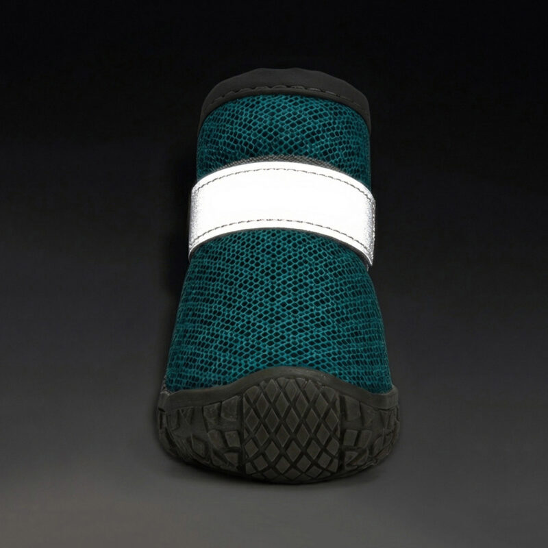 Front view of an ocean teal double wrap strap stay-on puppy shoe with its horizontal ankle band glowing brightly in the dark.