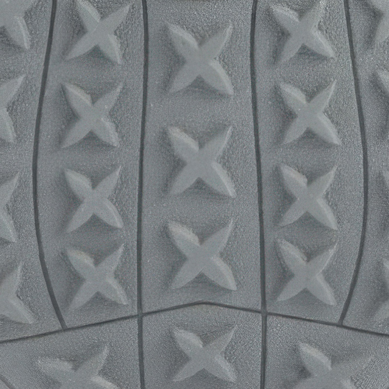 Structured macro detail of the prominent star tread pattern molded onto fleece lined rugged pet shoes outsoles.