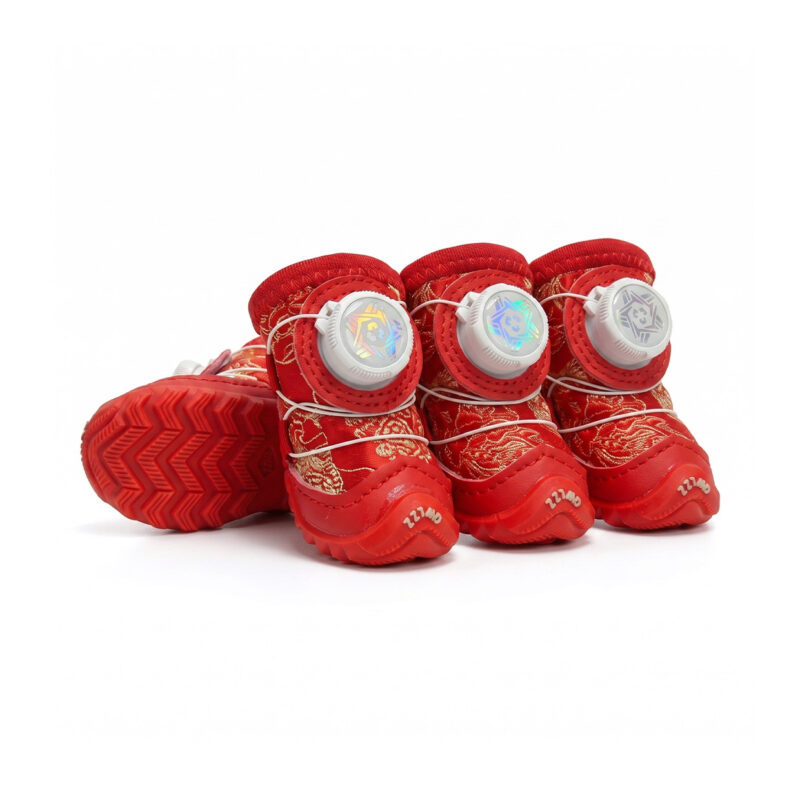 Crimson red dial-fit glow-in-the-dark dog shoes, featuring an adjustable rotary dial buckle, festive gold pattern fabric, and durable anti-slip rubber soles.