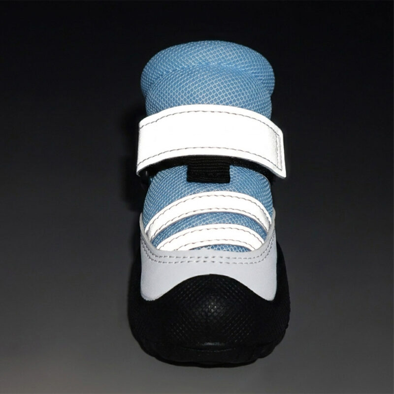 High-Visibility Night Safety Dog Boot Close-up of a blue night safety reflective pet shoe showing the double straps glowing brightly under dark conditions.