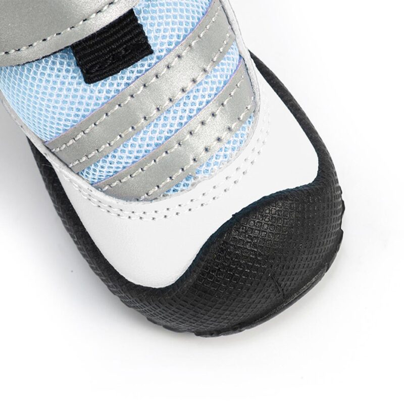 Reflective Strap and Toe Cap Close-Up Close-up of a blue night safety reflective pet shoe emphasizing the double stitched reflective bands and thick toe guard.