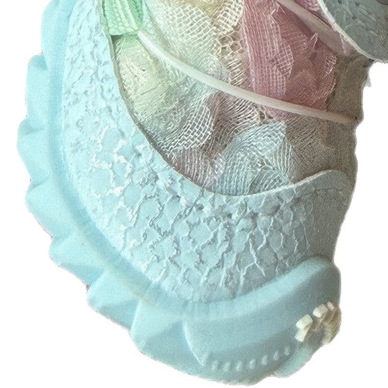 Lateral detail focusing on the pink scale textured leather mudguard and blue mesh side trim on small dog shoes.