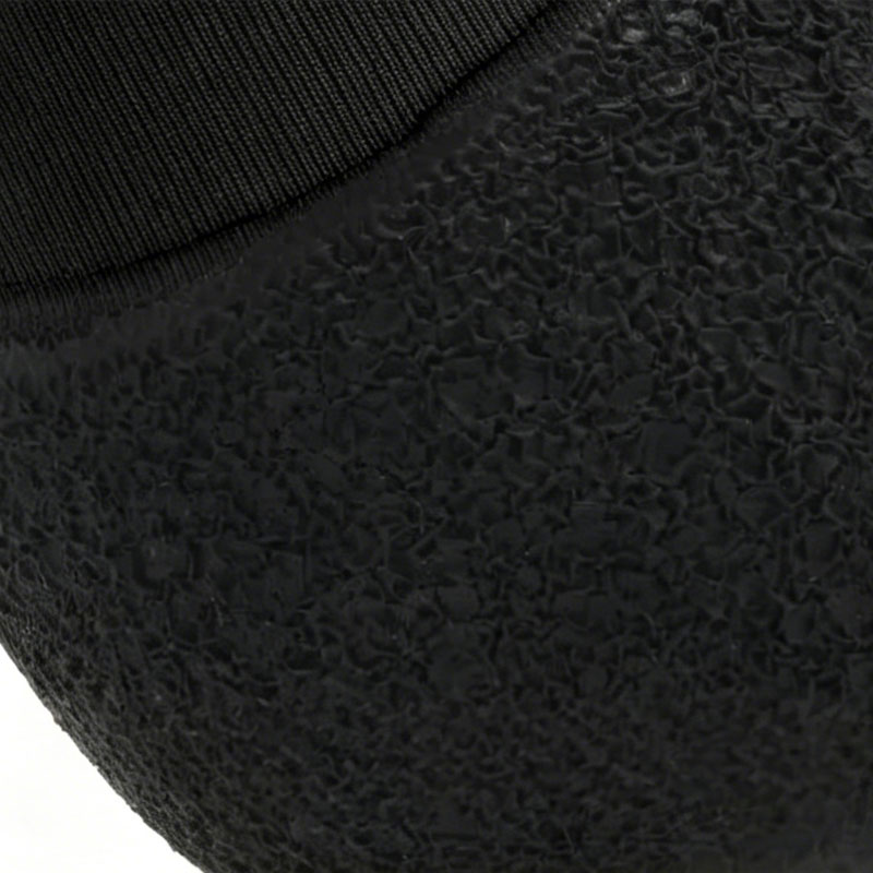 Detailed texture of the organic wrinkled grip on non-slip latex sole dog shoes for wet surfaces.