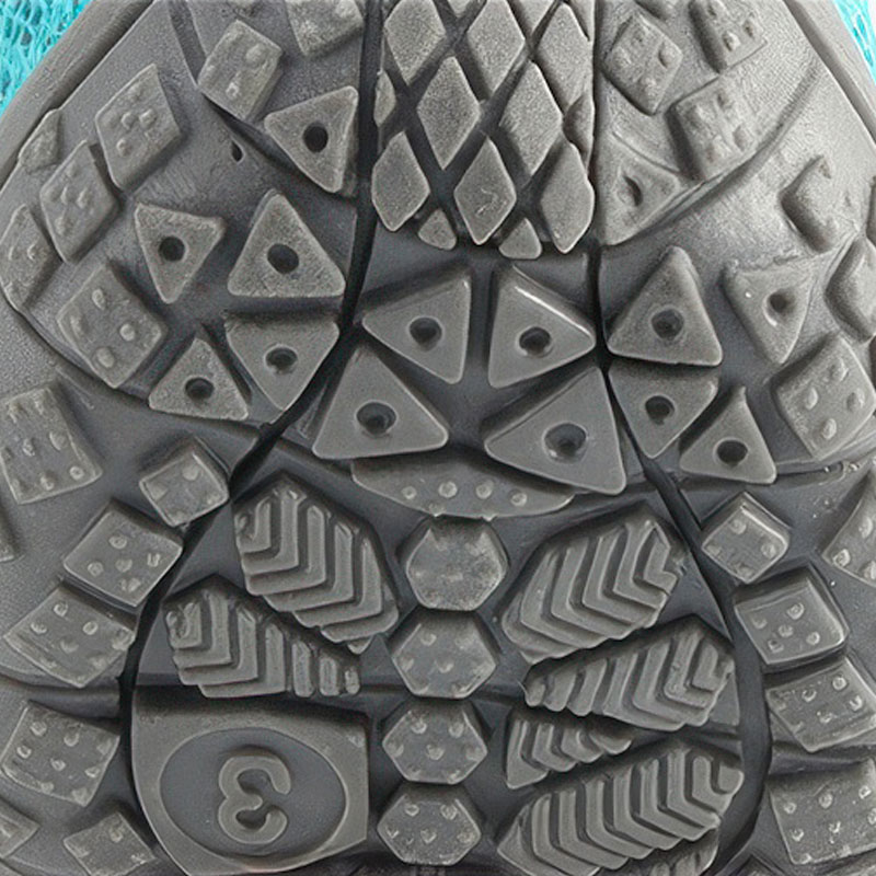 Underneath view showing the geometric traction nodes on the upgraded TPR outsole of dog shoes for hot pavement.