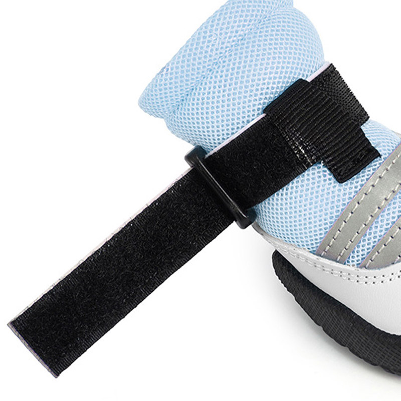 Detailed side profile showing the ankle strap threaded through the plastic pass-through ring on mesh dog boots.