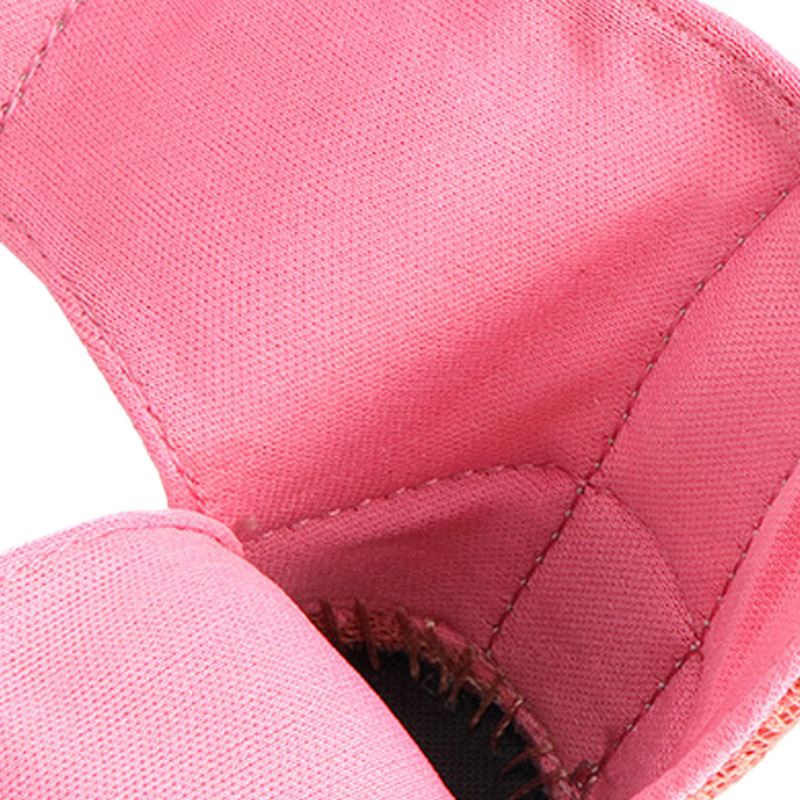 Macro view focusing inside a pink reflective breathable dog shoe showcasing the skin friendly soft interior lining.