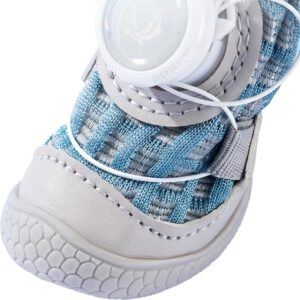 Close up look at the silver retroreflective strip, white wire guide path, and thick rubber front bumper on a blue shoe.