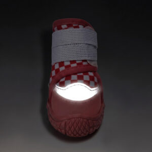 High Visibility Night Safety Reflective Toe Glow Front view of a red checker reflective waterproof dog shoe with its silver crescent toe patch glowing under low light.