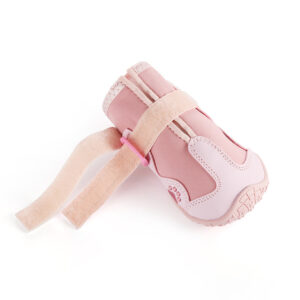Open Nylon Strap Fastener Detail A single pink snow walking shoe for dogs showing the unfastened adjustable hook and loop reflective ankle strap.