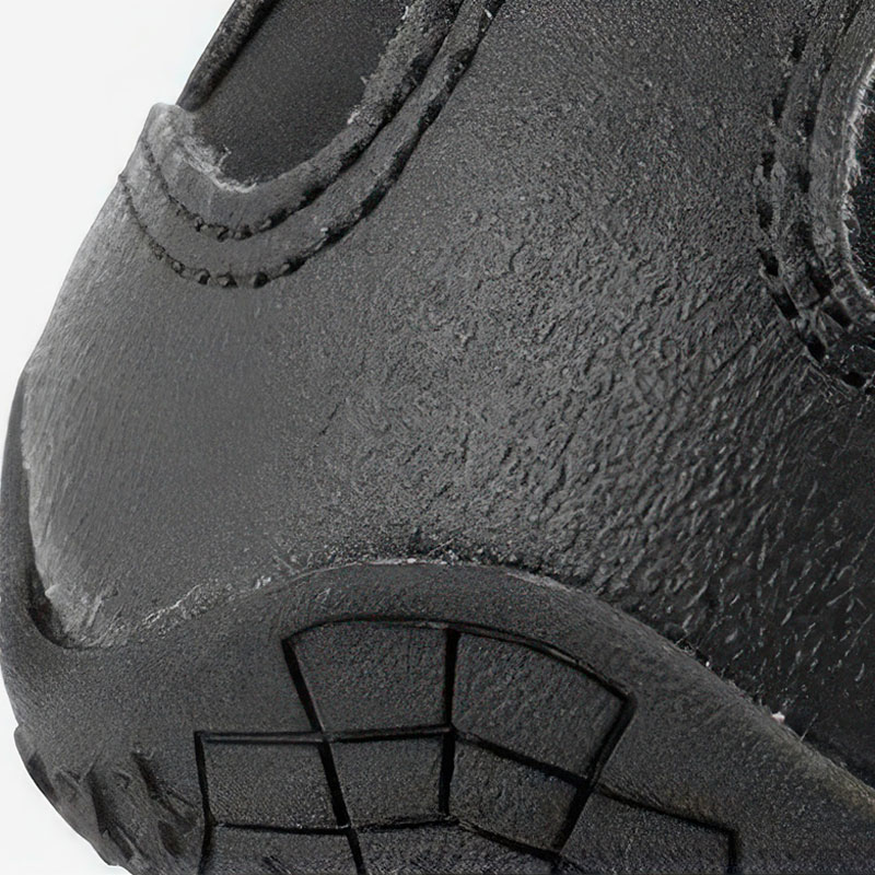 Close-up detail of the heavy-duty space leather toe guard paneled over the front profile of snow walking shoes for dogs.