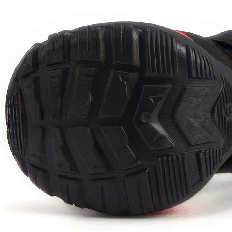 Underneath profile showing the flexible grooved tread on the black TPE sole of soft mesh dog shoes for hot pavement.