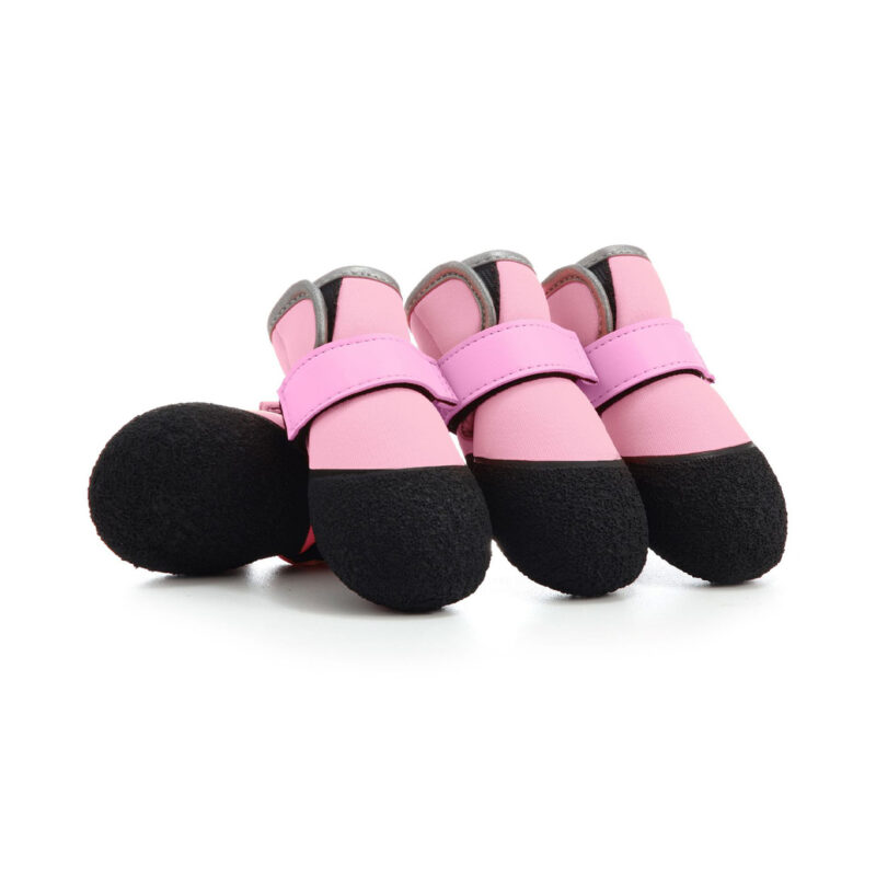 A set of pink soft-sole dog boots with flexible black rubber bottoms for indoor and outdoor protection.