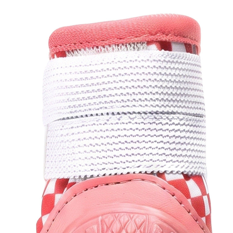 Close up look at the parallel dual hook and loop reflective straps wrapping the upper cuff on stay-on puppy shoes.
