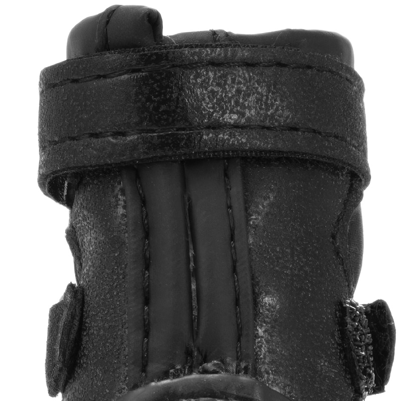 Detailed close up of the vertical leather reinforcement panel running down the back spinal seam of black dog boots.