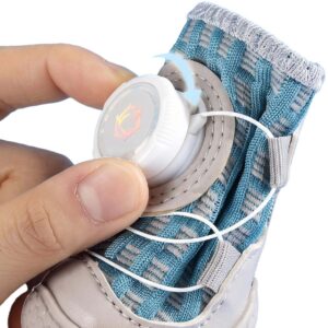 Macro profile of a hand rotating the white tension dial clockwise on stay-on mesh dog shoes to lock the wire cables.