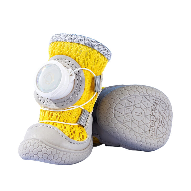 Front angle and underneath look at yellow stay-on mesh dog shoes highlighting the molded grey chevron suction tread lines.