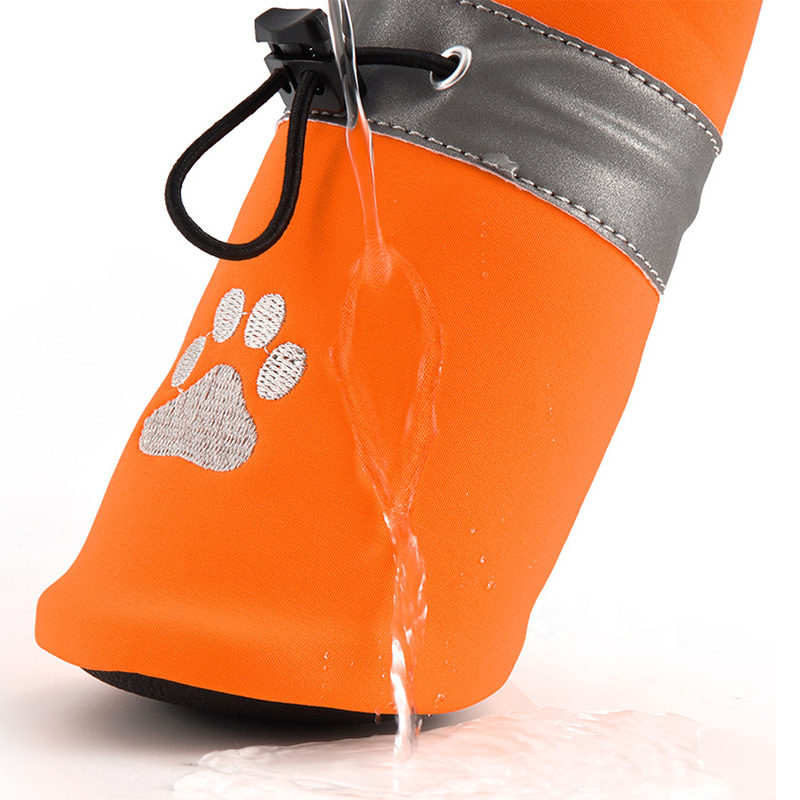 Close-up macro view of water pouring and beading over the quick-drying water-resistant fleece dog shoes textile shell.