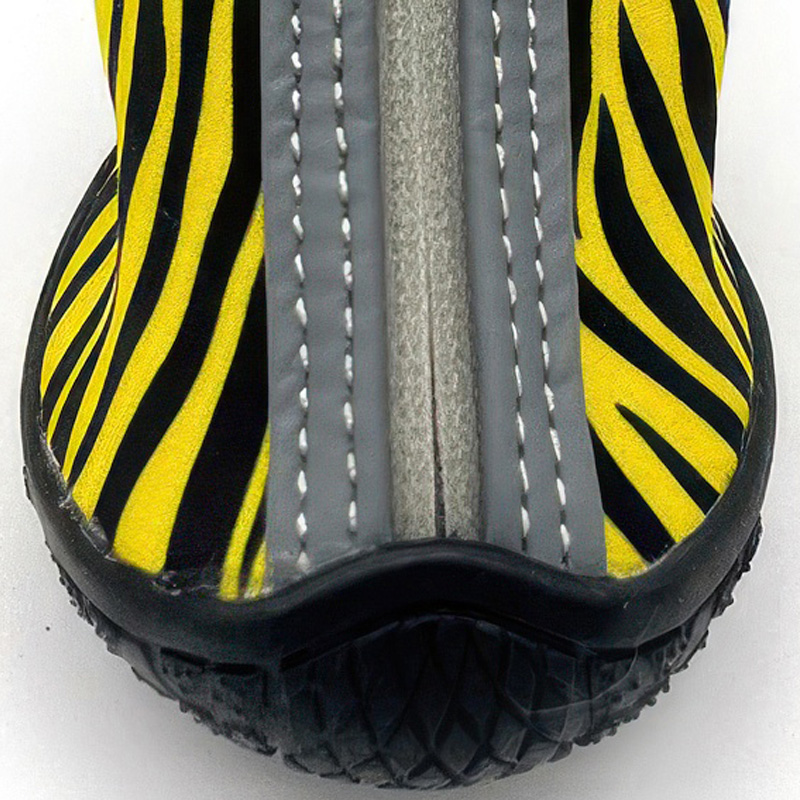 Front profile detailing the reinforced rubber edge bumper and water-resistant fabric shell on outdoor shoes for small dogs.