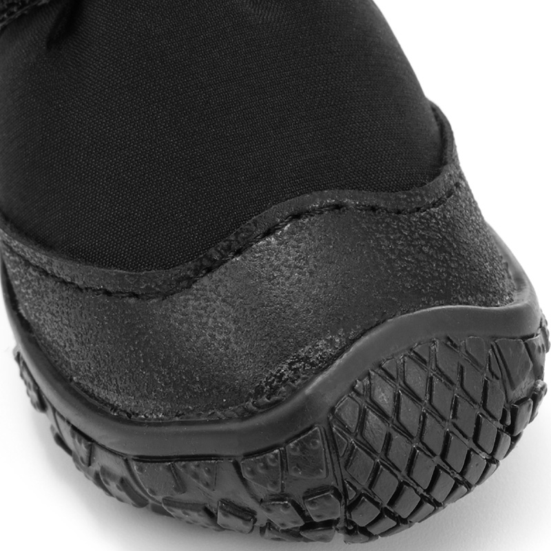Profile view of a black dog shoe illustrating the clean seam fusion between waterproof stretch canvas and a thick rubber toe guard.