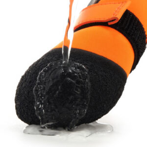 Water running over the latex bottom of waterproof neoprene dog shoes proving total moisture protection.