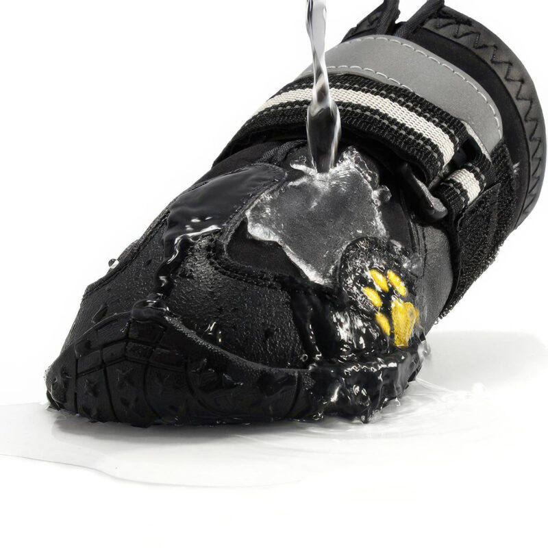 Hydrophobic Fabric Shell Water Resistance Test Water pouring directly onto a black waterproof warm dog shoe to demonstrate the nano-porous water-repellent fabric shell.