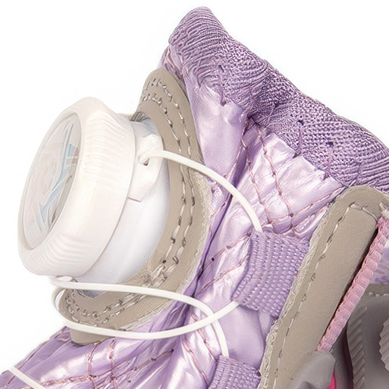 Macro look at the white mechanical cable dial and close interlocking needle stitching lines on purple winter waterproof dog shoes.