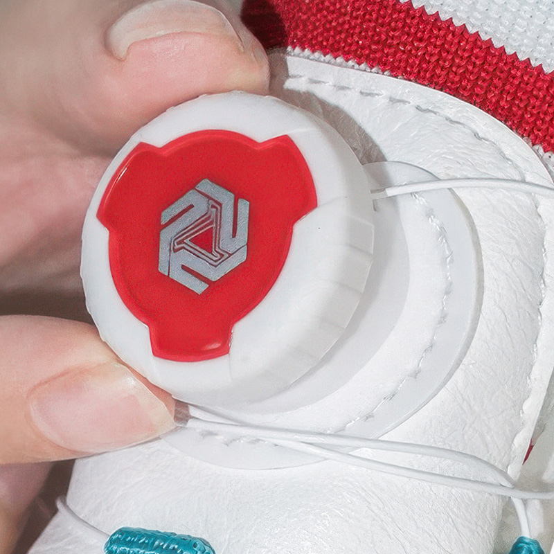 Close up profile of the red mechanical ratchet dial on adjustable cable dog shoes with micro wire guides.