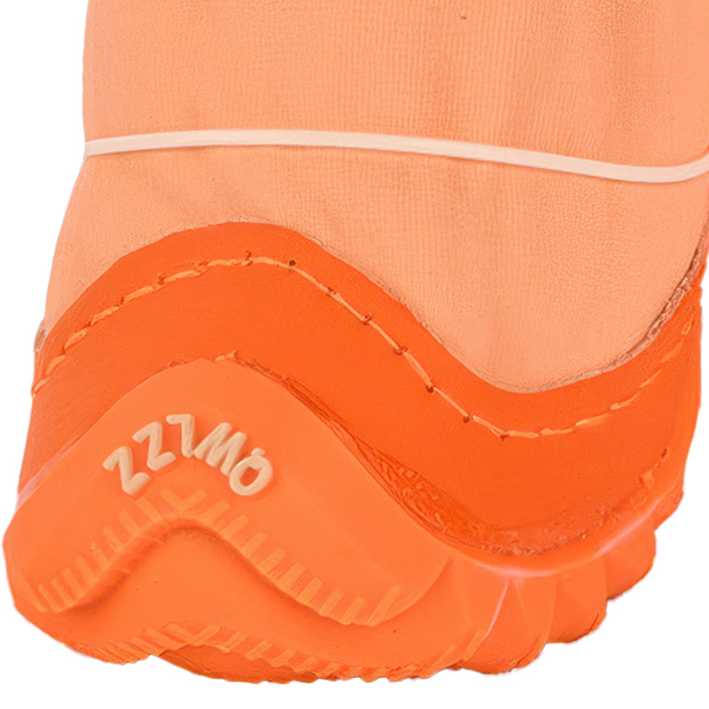 Structural profile detail of an orange water-resistant dog boot showing the clean seam joining the upper canvas.