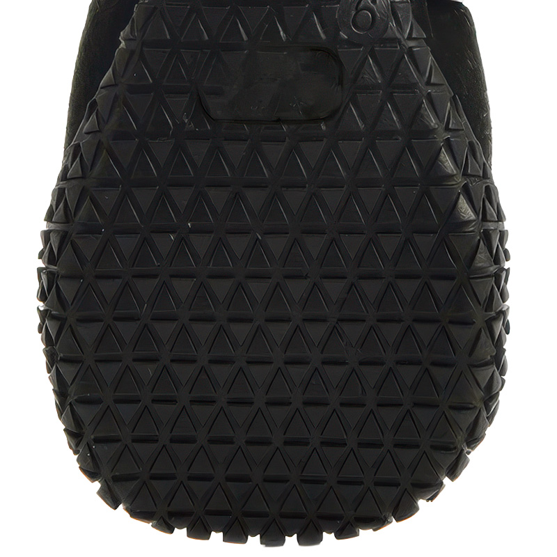 Puncture-resistant black rubber outsole on anti-slip rubber sole boots displaying automotive tire tread groove patterns.