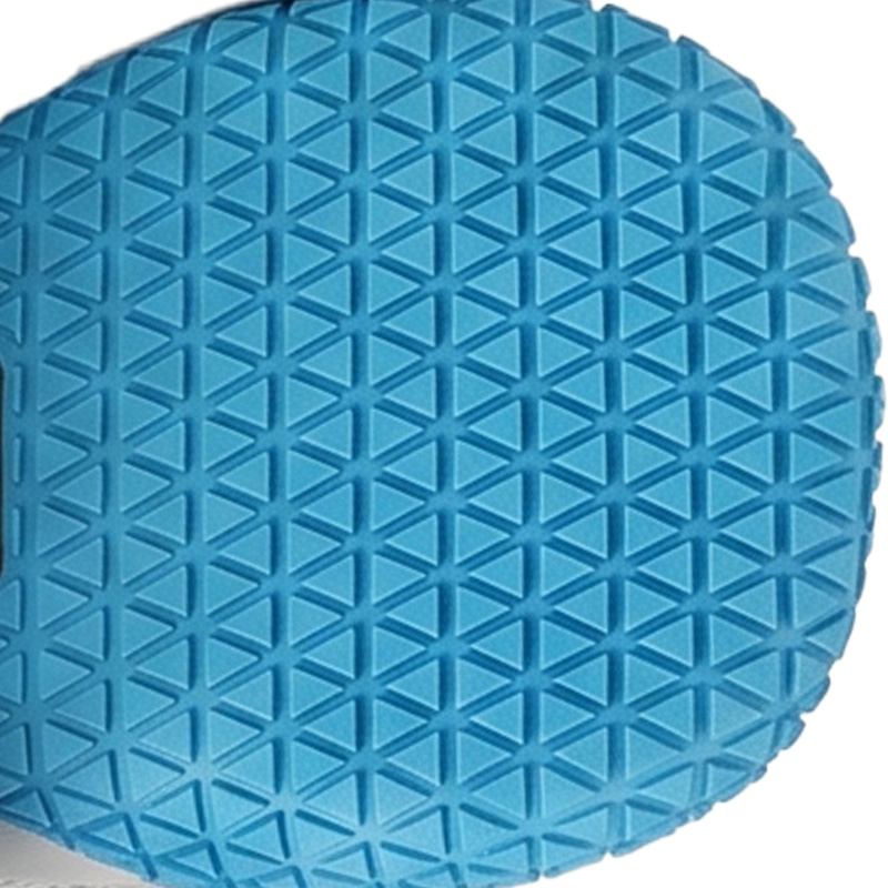 Bright blue anti-slip rubber sole dog boots showcasing a dense deep-groove triangular traction matrix.