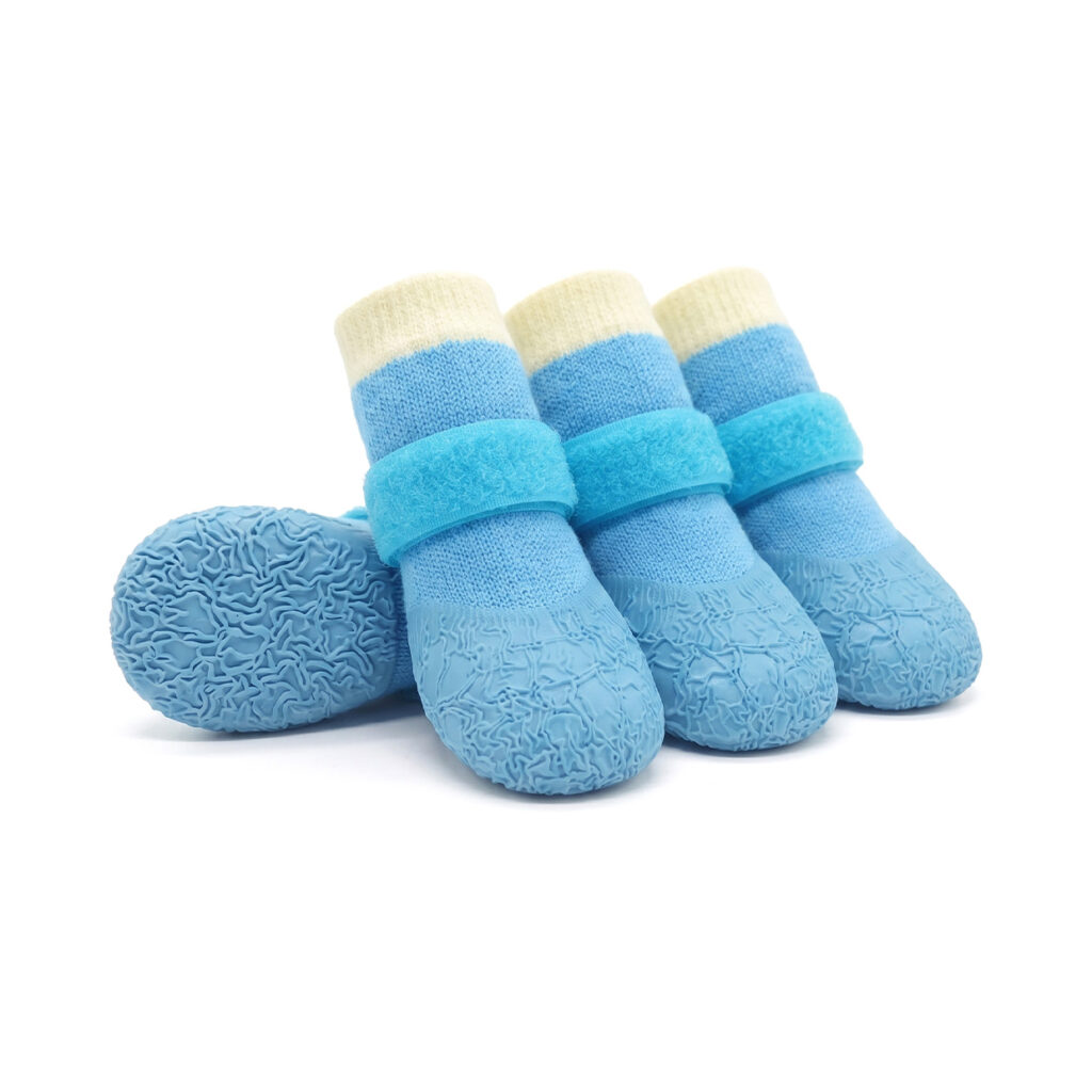 Sky blue anti-slip textured dog socks with secure velcro straps and blue wrinkled rubber non-slip bottoms.