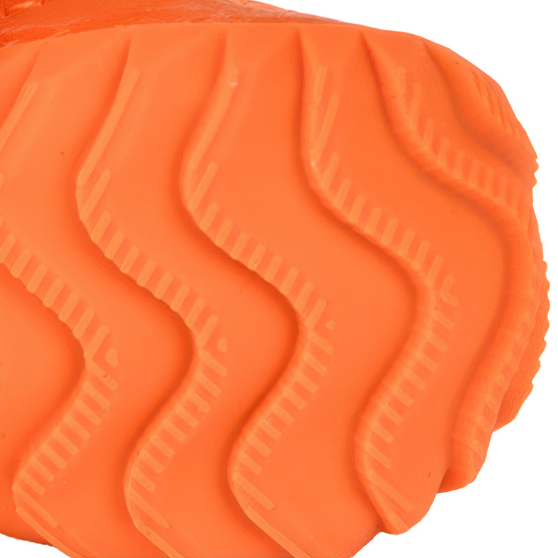 Underneath look at the textured orange rubber base profile showing deep progressive chevron wave tread grooves.