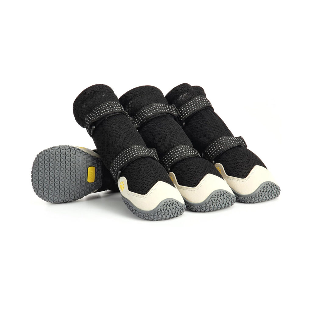 Premium breathable mesh dog boots in black and cream featuring four structured booties with non-slip rubber soles.