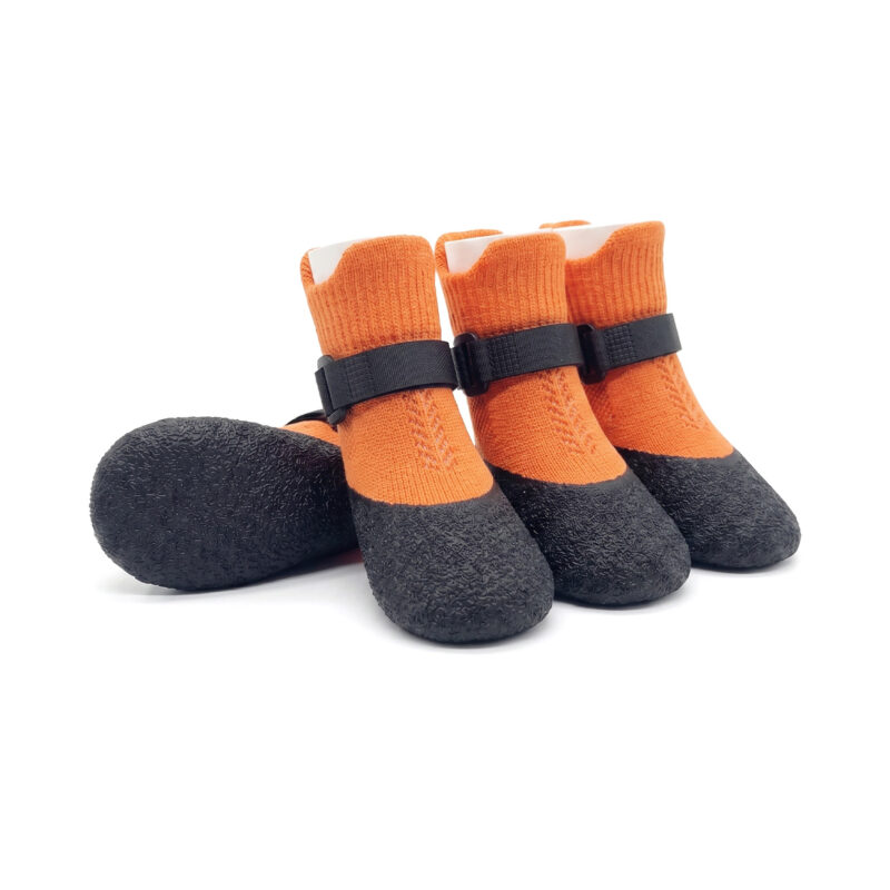 Tangerine orange dog socks with straps that stay on featuring waterproof black latex dipped bottoms.