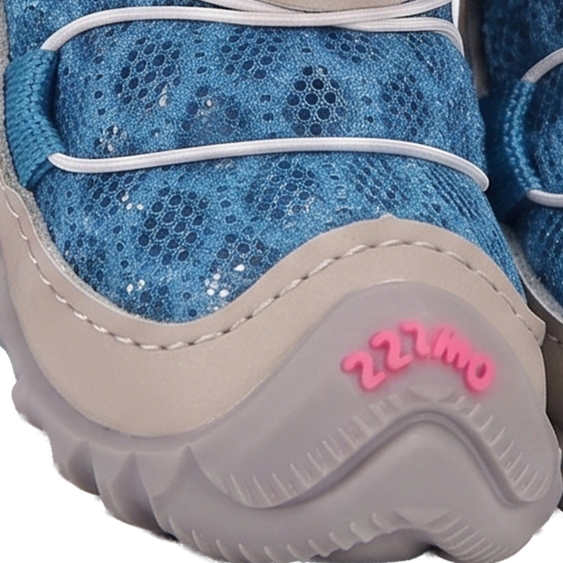 Front angle detail highlighting the gray synthetic mudguard wrap and pink logo branding on a blue puppy shoe.