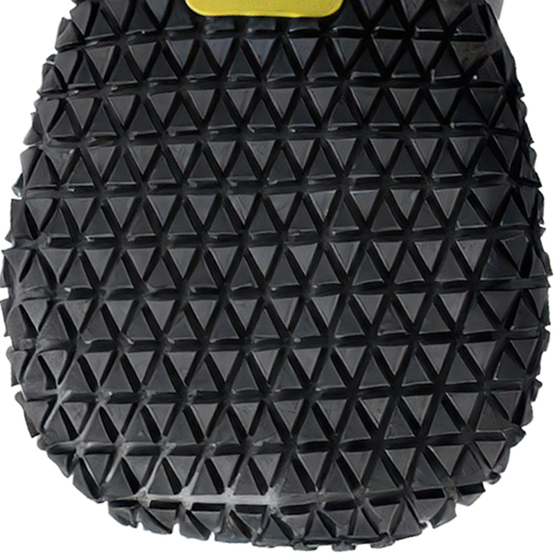 Vulcanized black outsole on cold-weather dog boots displaying an intense non-slip geometric tread pattern grid.